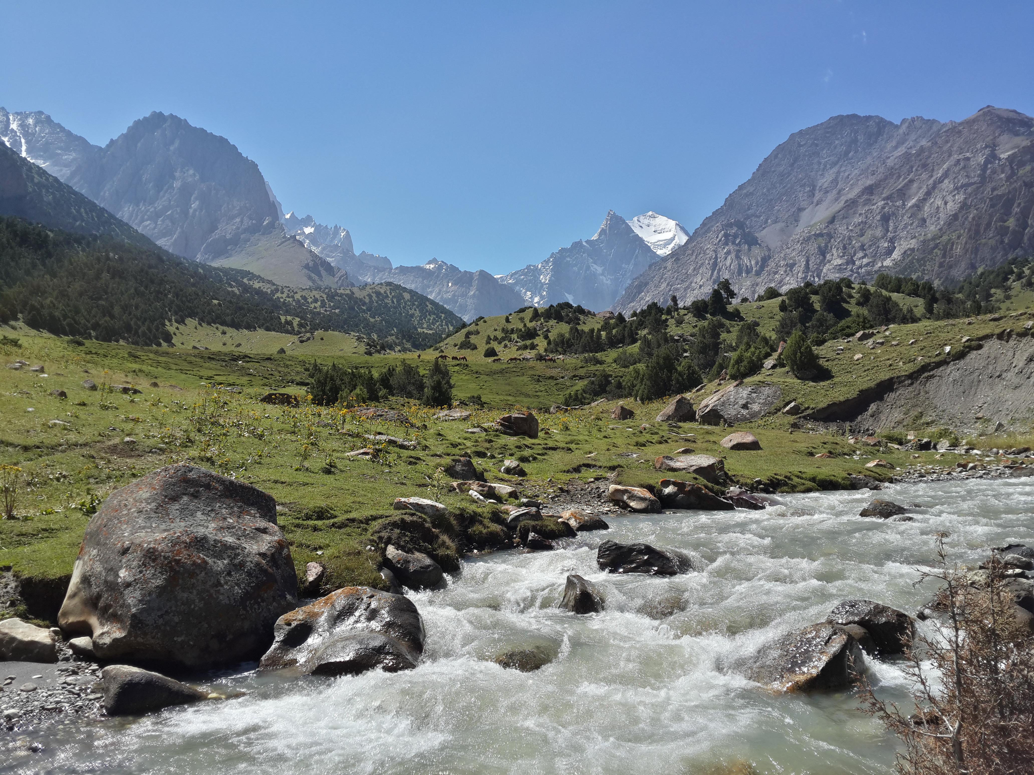 Dramatic mountain landscape in Kyrgyzstan at dusk with starry sky